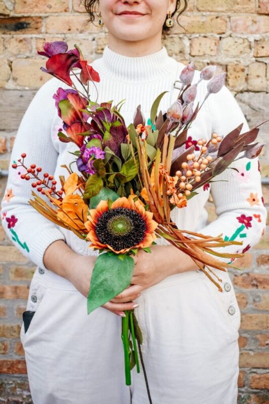 person holding a faux floral bouquet