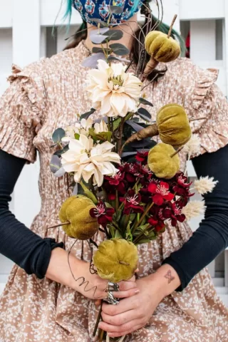 person holding a faux floral bouquet