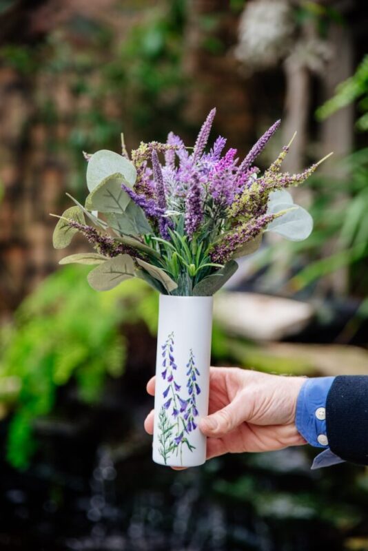 faux floral arrangement in a delicate white vase