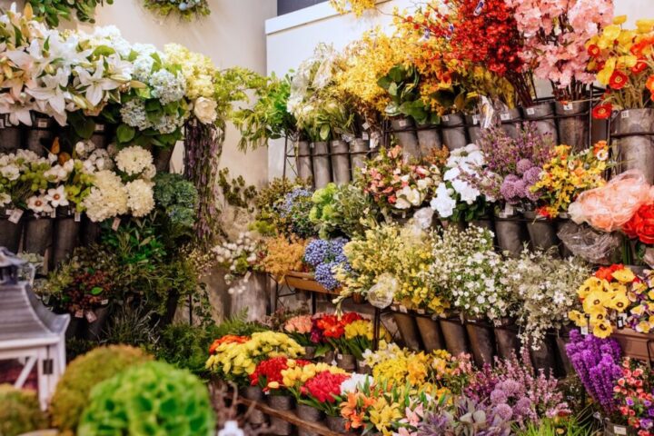 wall of faux florals in cylindrical tubs