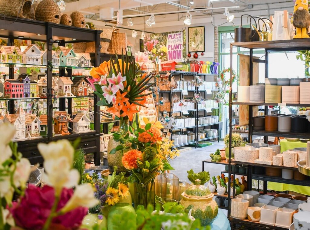 warm interior shot of shelves filled with home decor like pottery, birdhouses, and more