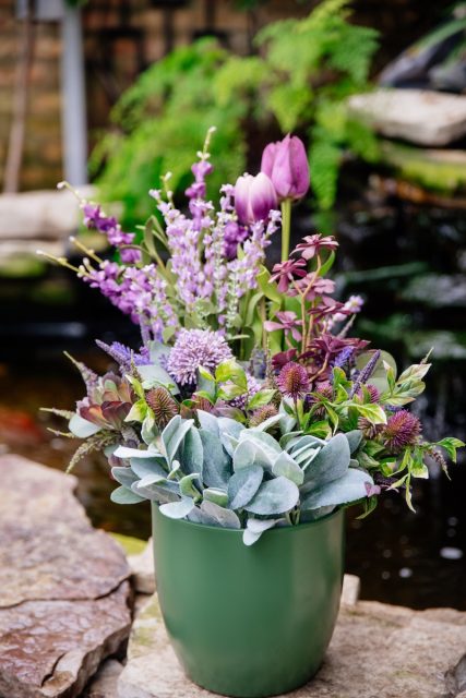 faux floral arrangement in a green pot